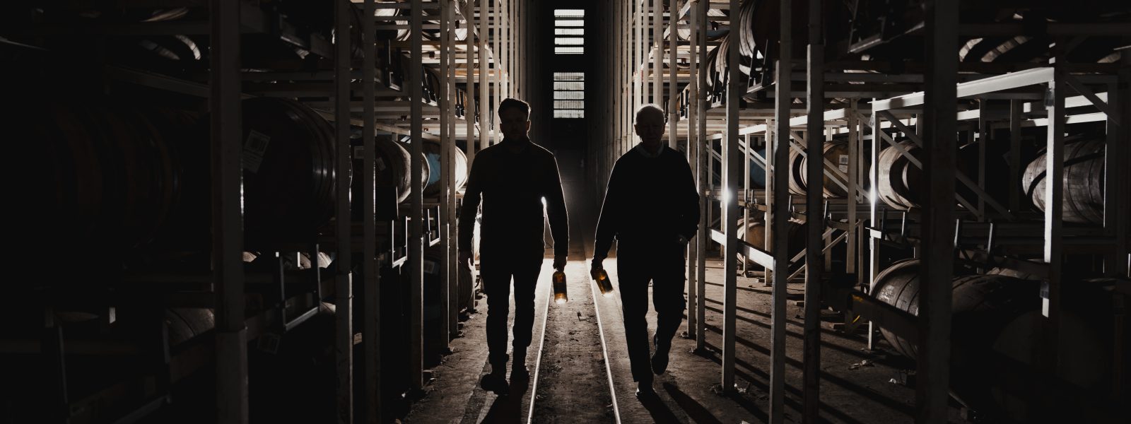 Master Distiller, Billy Walker and Assistant Blender, Ronan Currie walking through the warehouse.