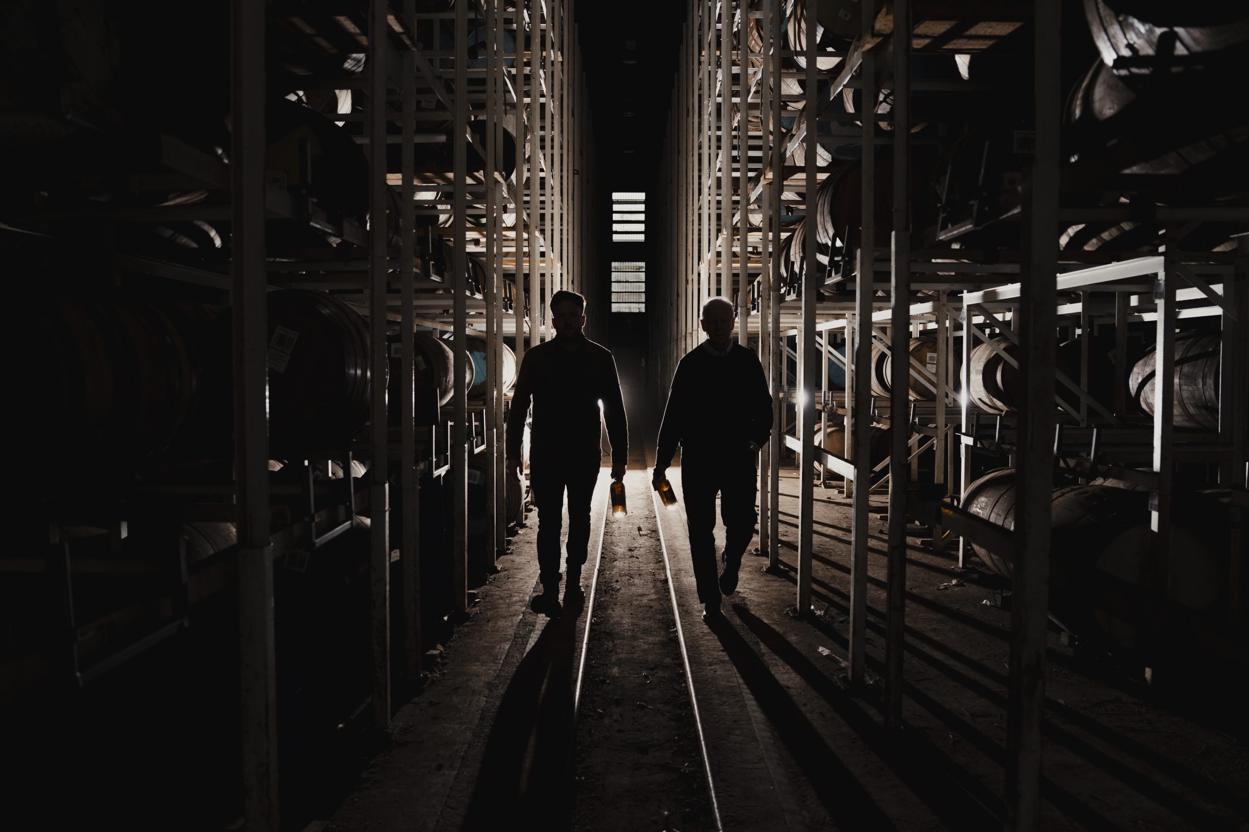 Master Distiller, Billy Walker and Assistant Blender, Ronan Currie walking through the warehouse.